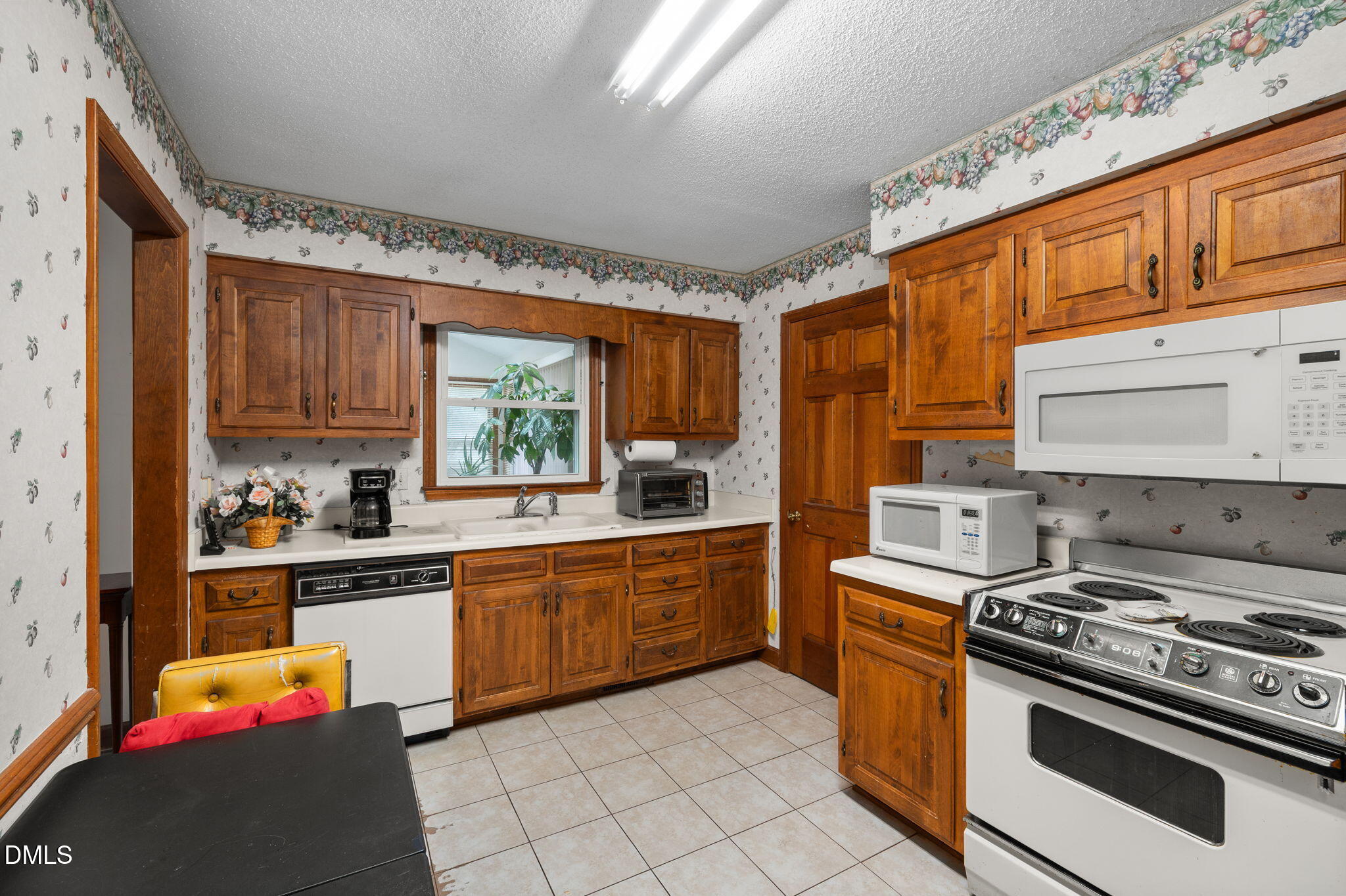 2024 Angier Road Fuquay-Varina, NC 27526 - Photo 11 of 35 a kitchen with stainless steel appliances granite countertop a stove a sink dishwasher and cabinets with wooden floor