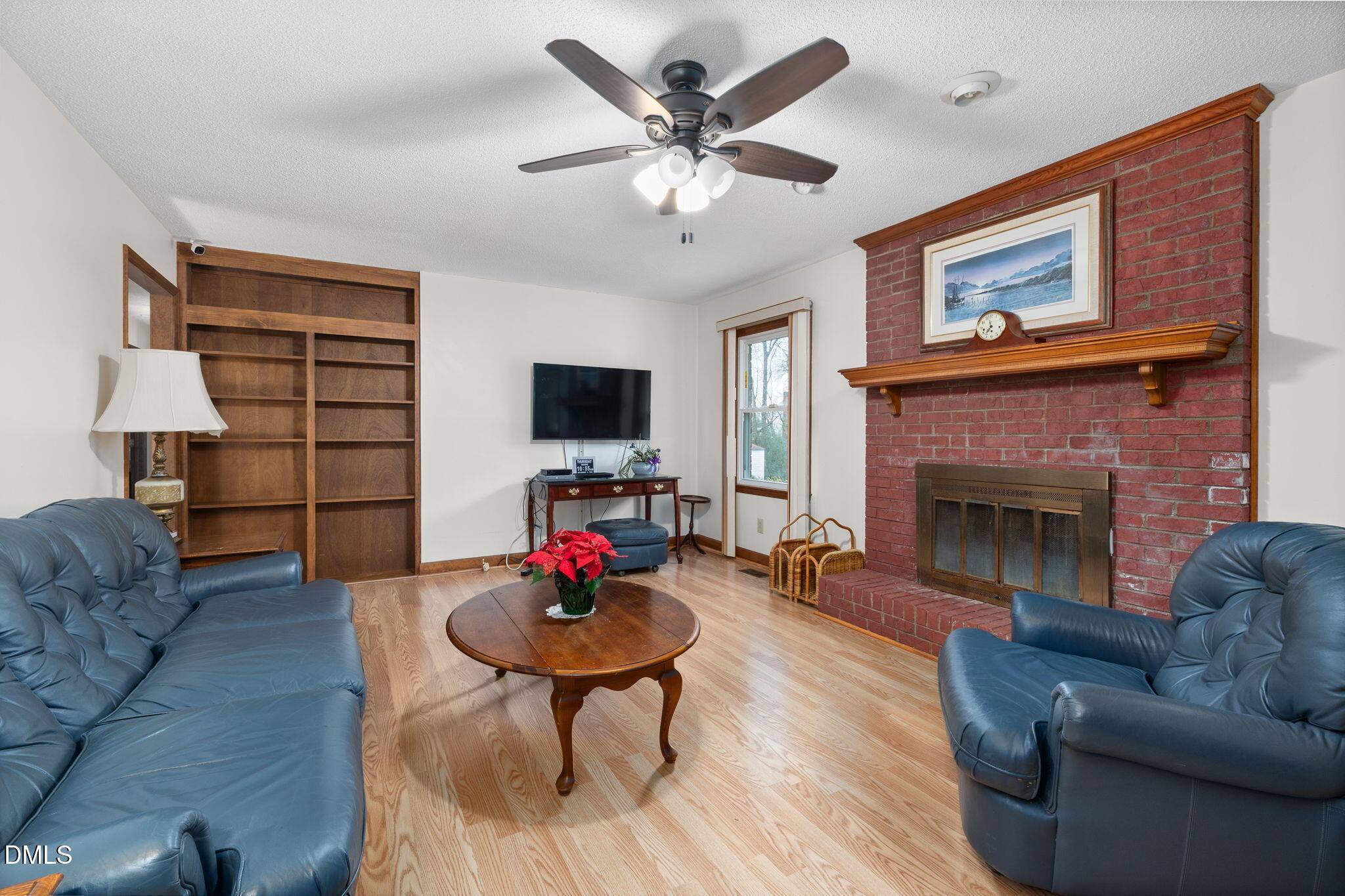 2024 Angier Road Fuquay-Varina, NC 27526 - Photo 12 of 35 a living room with furniture and a fireplace