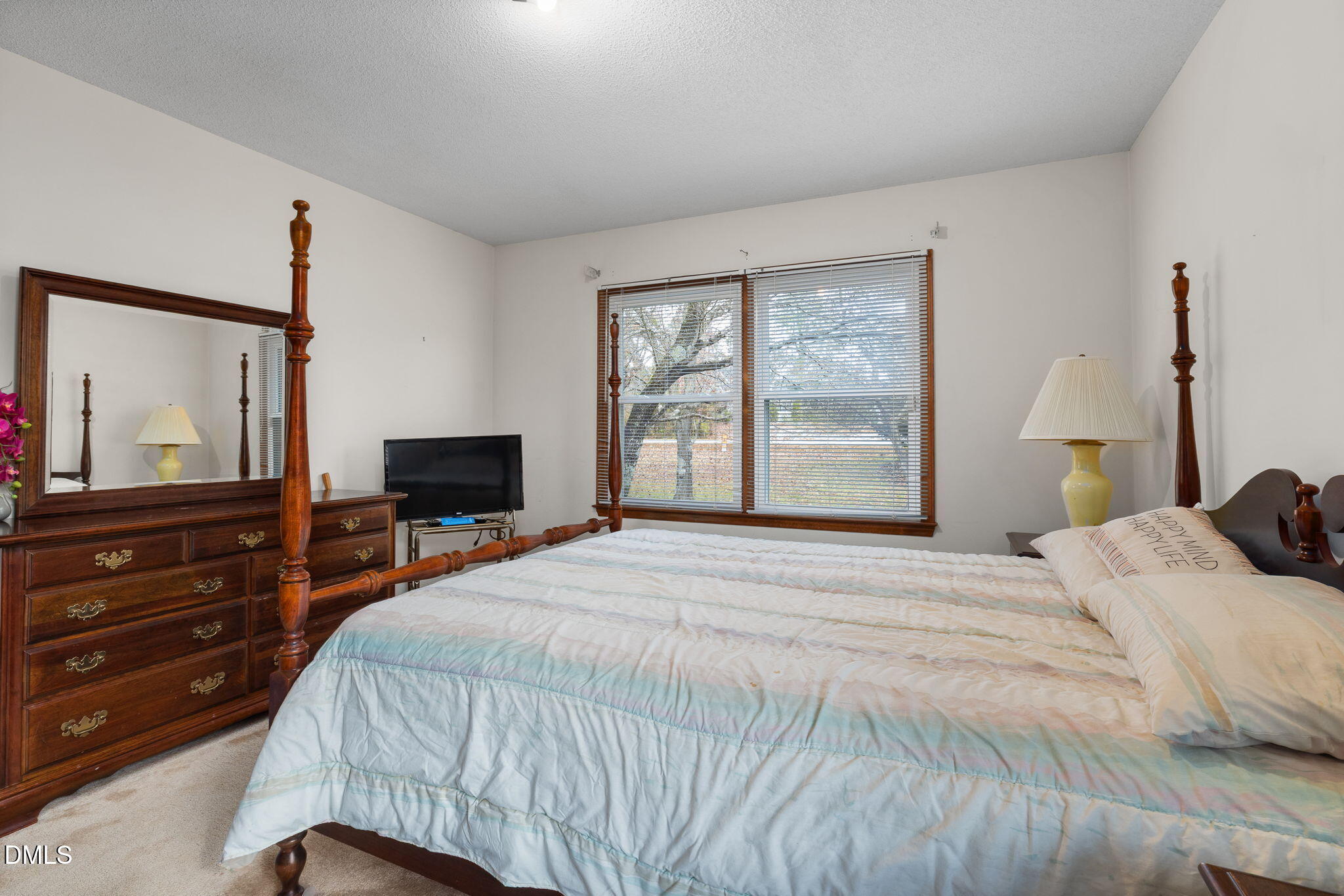 2024 Angier Road Fuquay-Varina, NC 27526 - Photo 19 of 35 a bedroom with a bed and a flat screen tv