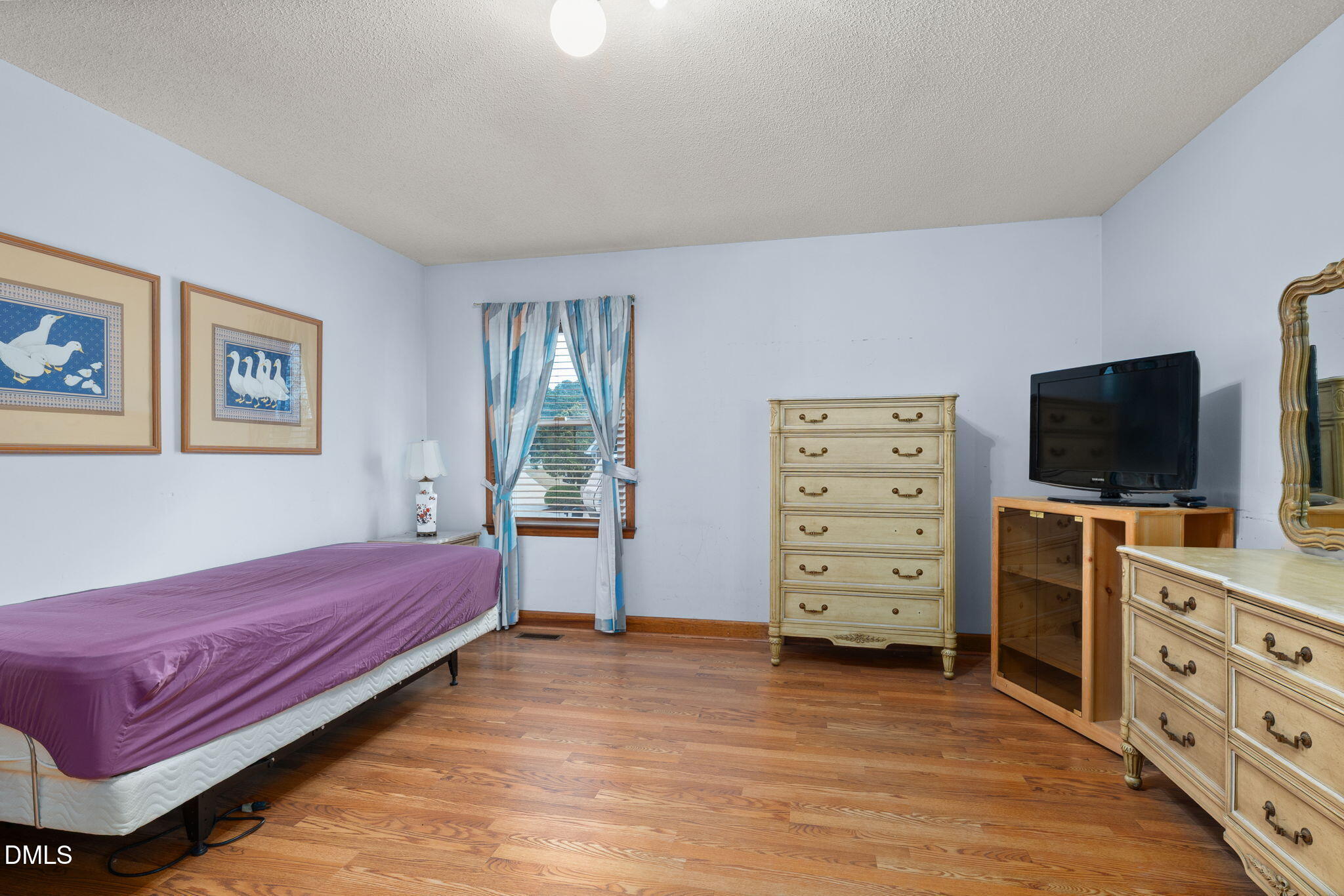 2024 Angier Road Fuquay-Varina, NC 27526 - Photo 21 of 35 a living room with furniture and a flat screen tv