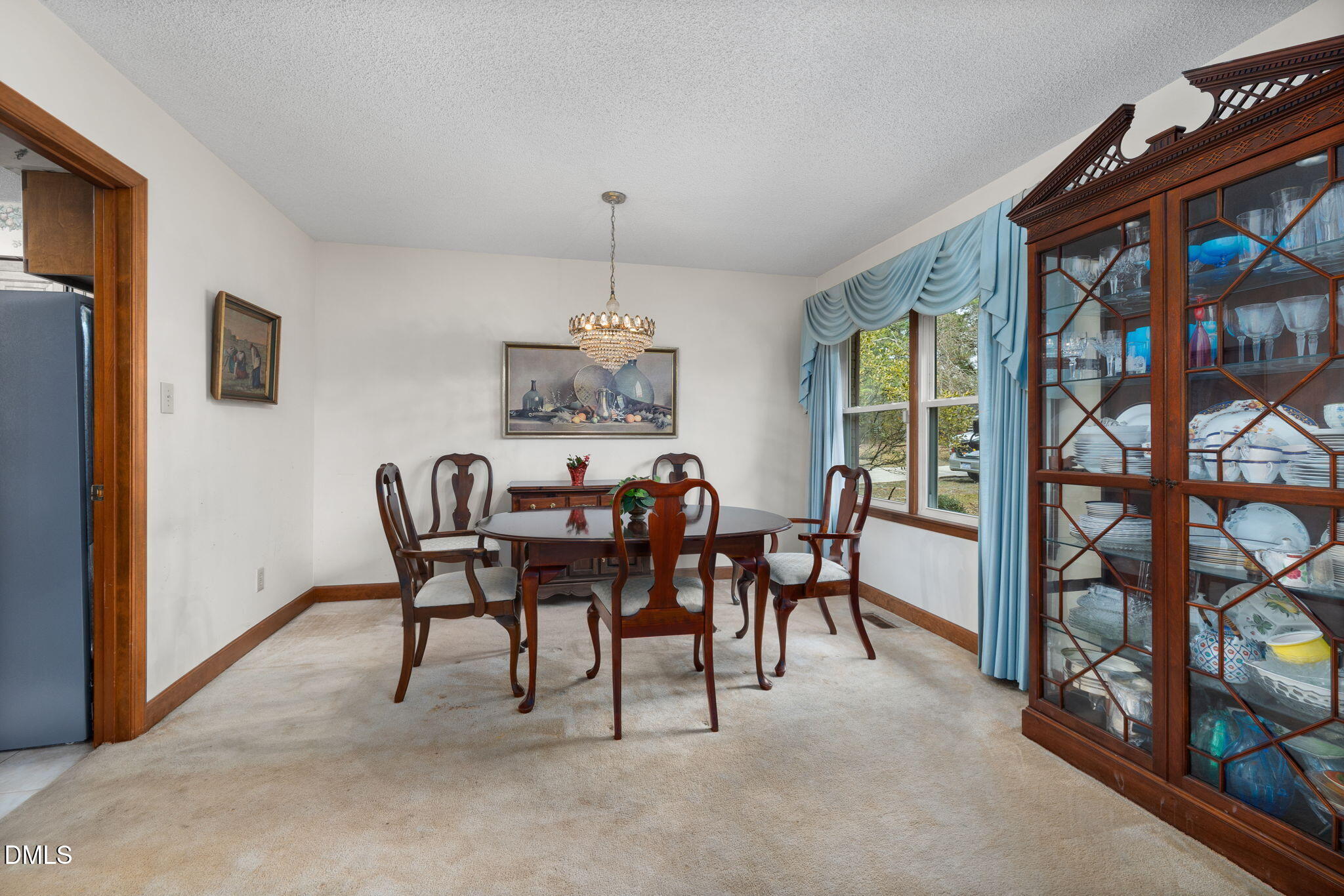 2024 Angier Road Fuquay-Varina, NC 27526 - Photo 7 of 35 a view of a dining room with furniture and a chandelier