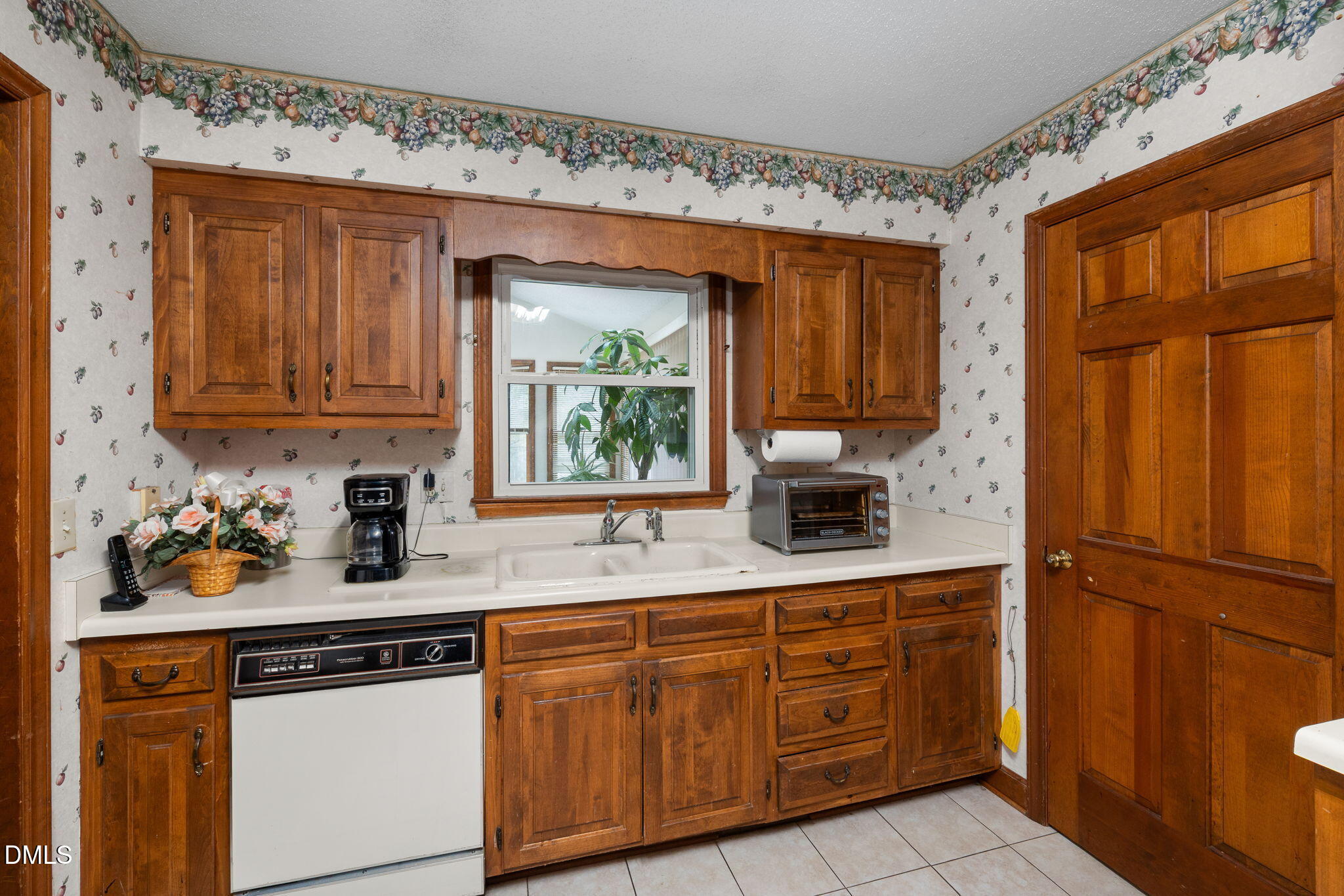 2024 Angier Road Fuquay-Varina, NC 27526 - Photo 9 of 35 a kitchen with granite countertop stainless steel appliances a stove sink and cabinets