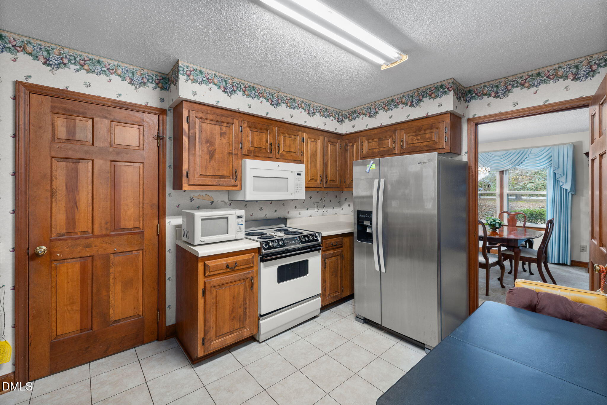 2024 Angier Road Fuquay-Varina, NC 27526 - Photo 10 of 35 a kitchen with stainless steel appliances granite countertop a refrigerator a stove and a sink with large cabinets