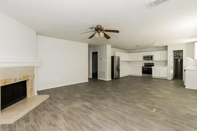 a view of a kitchen with a sink a kitchen a refrigerator and a stove top oven