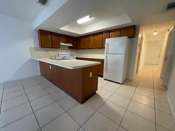 a kitchen with stainless steel appliances granite countertop a stove a refrigerator and a cabinets