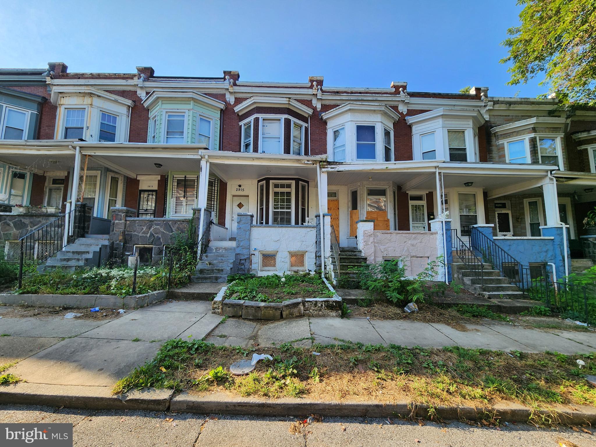 a front view of a residential apartment building with a yard
