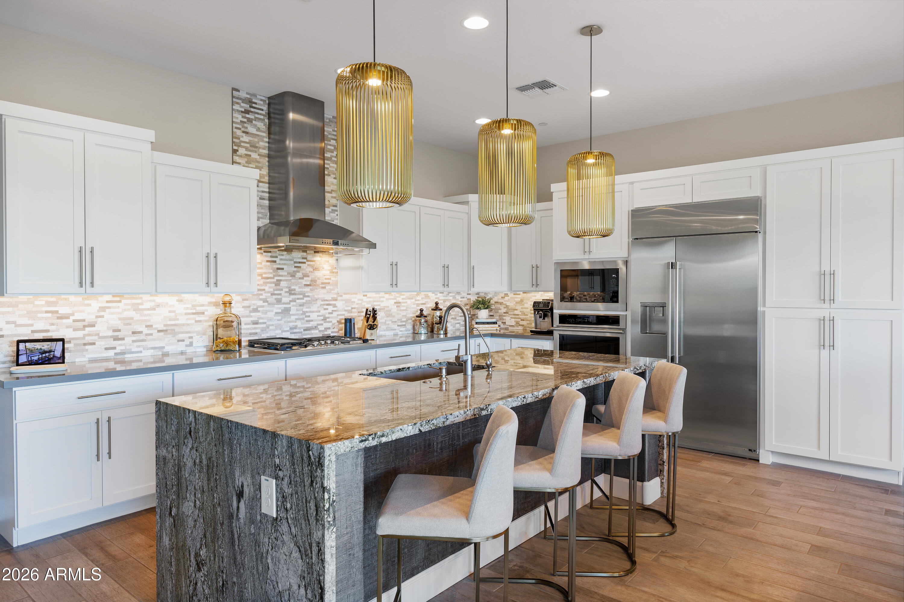 28803 North Sandal Court Rio Verde, AZ 85263 - Photo 11 of 85 a kitchen with stainless steel appliances granite countertop a kitchen island a stove a table and chairs