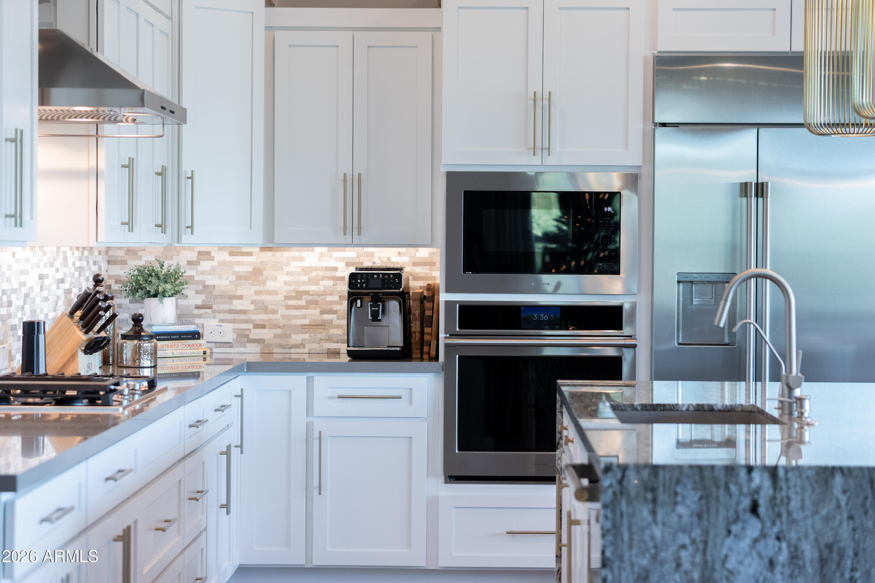 28803 North Sandal Court Rio Verde, AZ 85263 - Photo 13 of 85 a kitchen with kitchen island granite countertop a stove a sink and a microwave