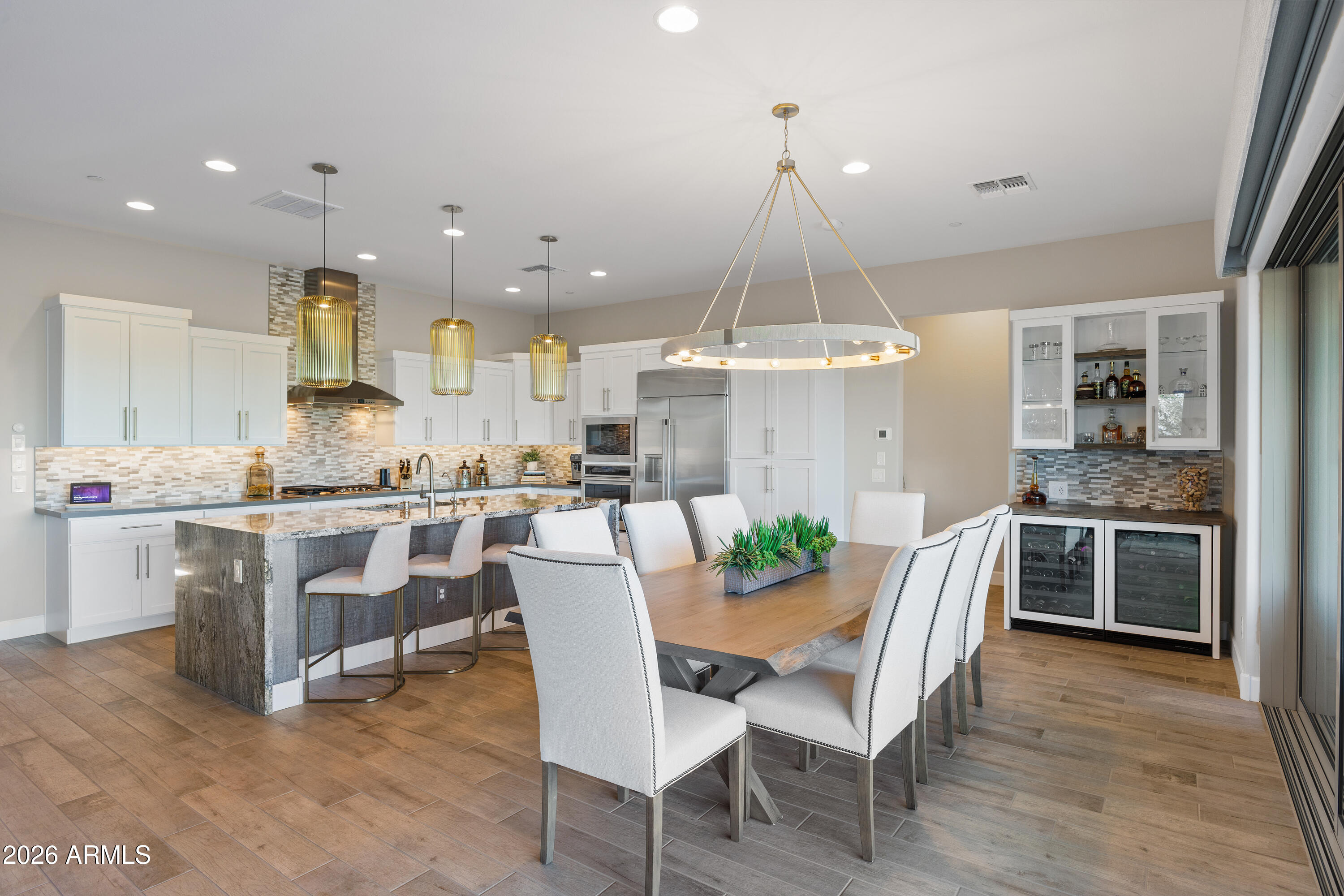 28803 North Sandal Court Rio Verde, AZ 85263 - Photo 17 of 85 a dining room with a table chairs and a kitchen view