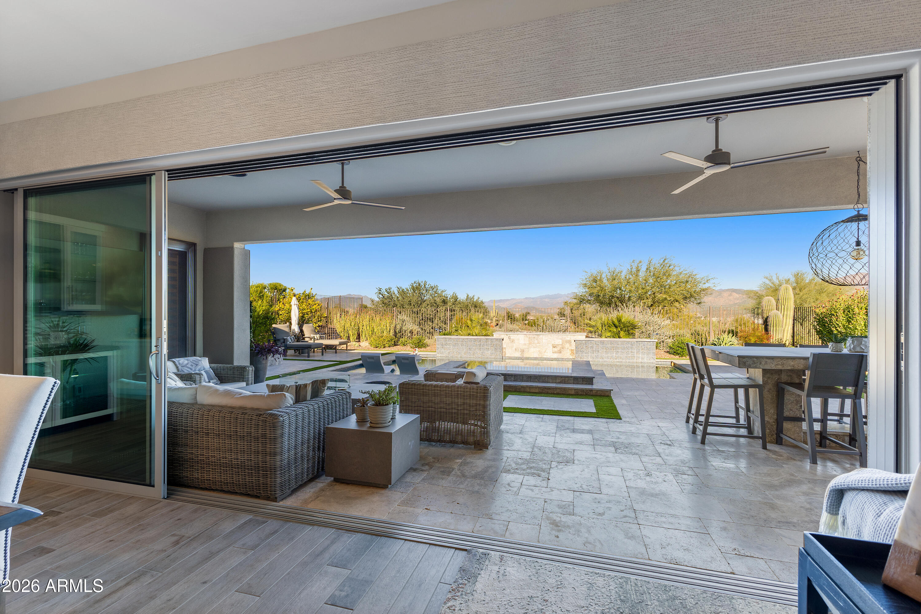 28803 North Sandal Court Rio Verde, AZ 85263 - Photo 22 of 85 a living room with furniture a flat screen tv and a floor to ceiling window