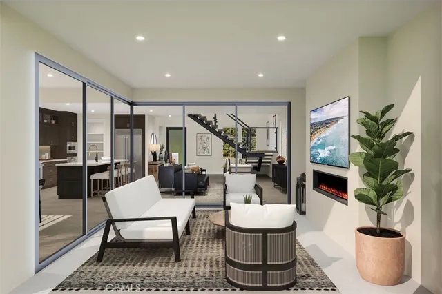 a living room with furniture a flat screen tv and a potted plant