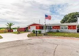 a front view of multi story residential apartment building with yard