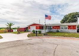 a front view of multi story residential apartment building with yard