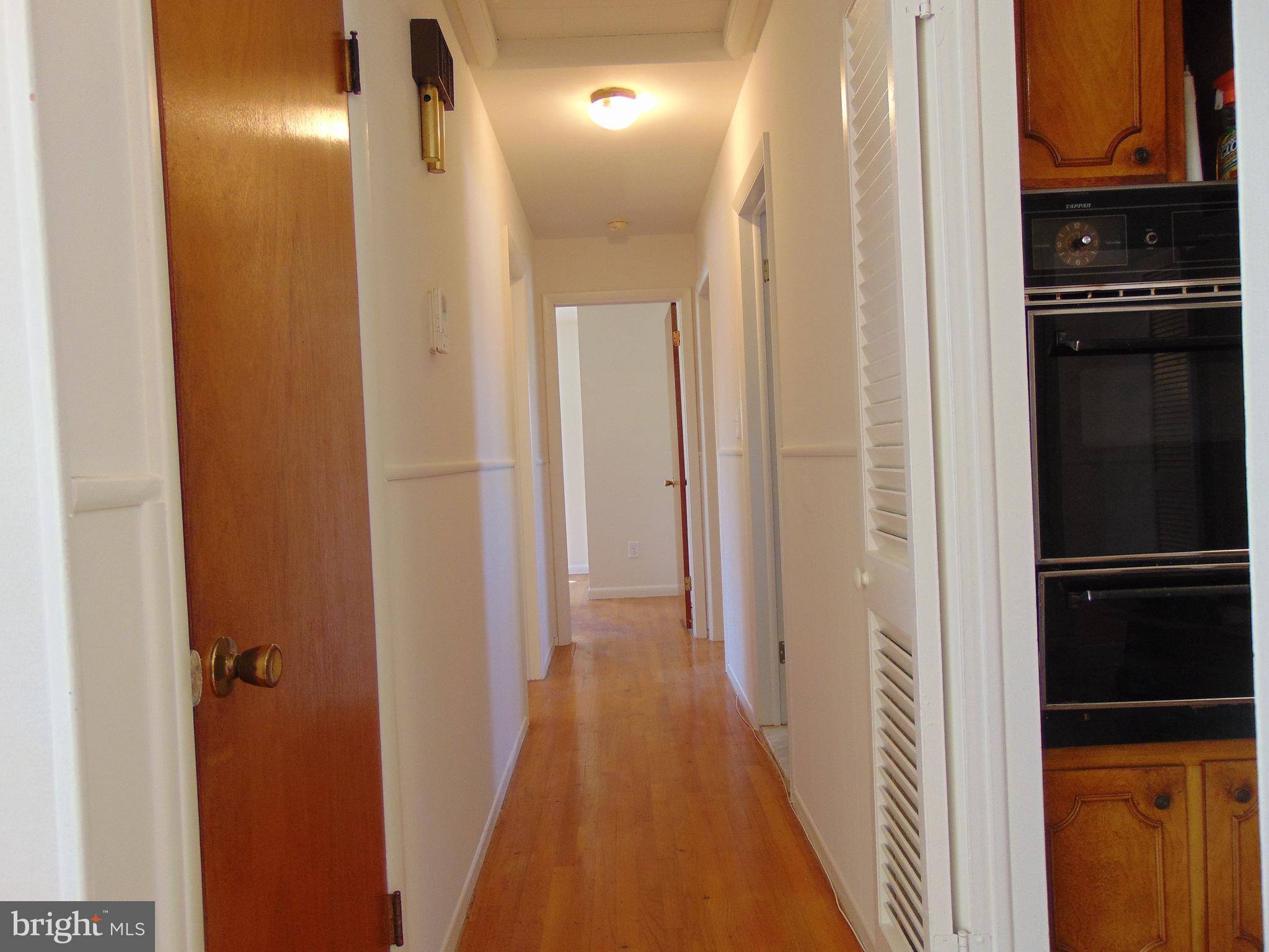 760 Hawthorne Road Linthicum Heights, MD 21090 - Photo 23 of 82 Looking down hallway with kitchen to right.