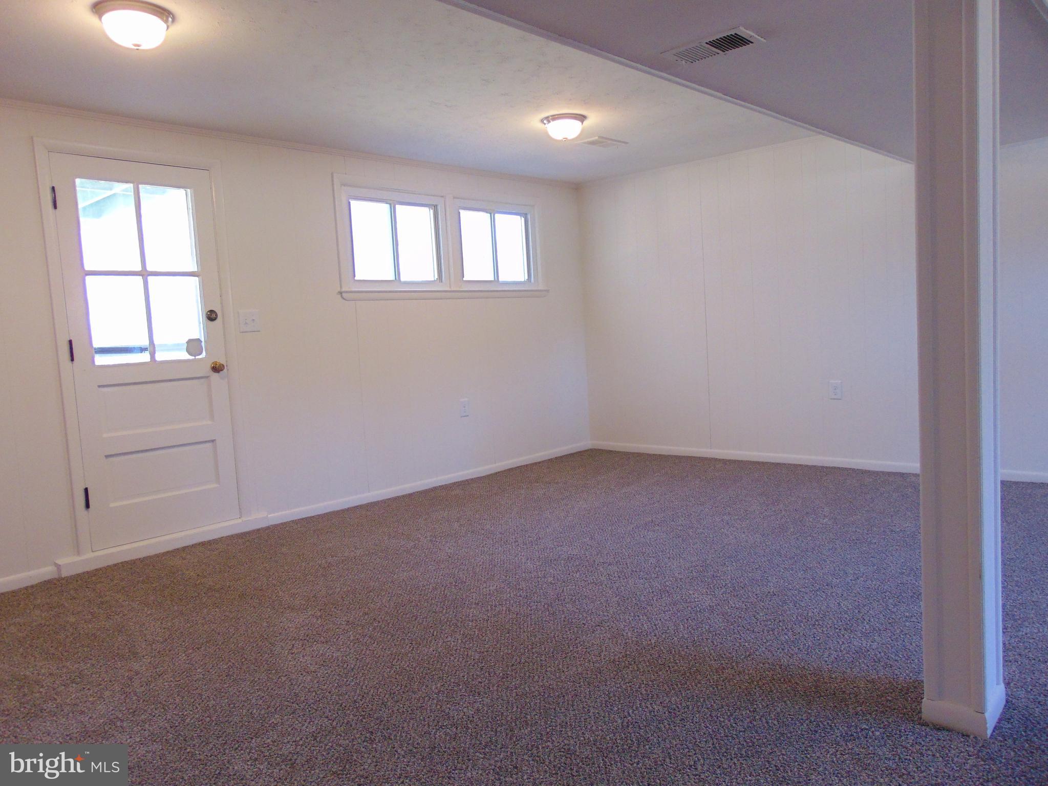 760 Hawthorne Road Linthicum Heights, MD 21090 - Photo 50 of 82 Basement with fresh carpet and door to backyard.