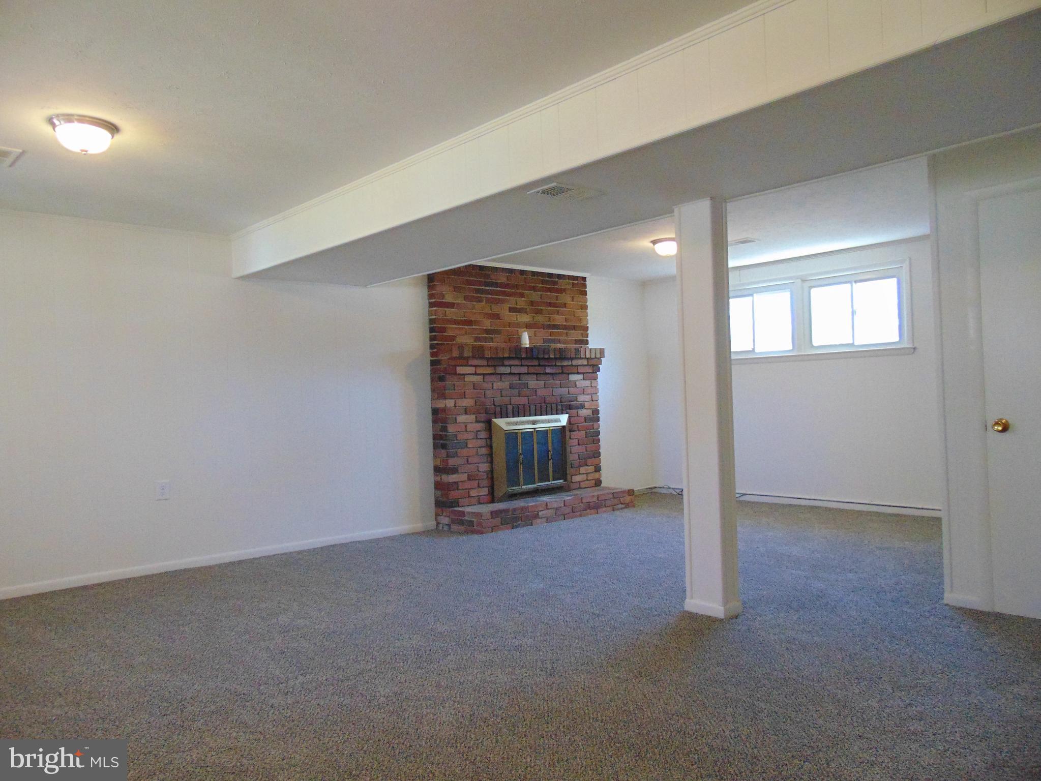 760 Hawthorne Road Linthicum Heights, MD 21090 - Photo 51 of 82 Basement gas fireplace with fresh paint and carpet