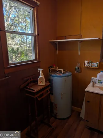 a room with a sink cabinets and wooden floor