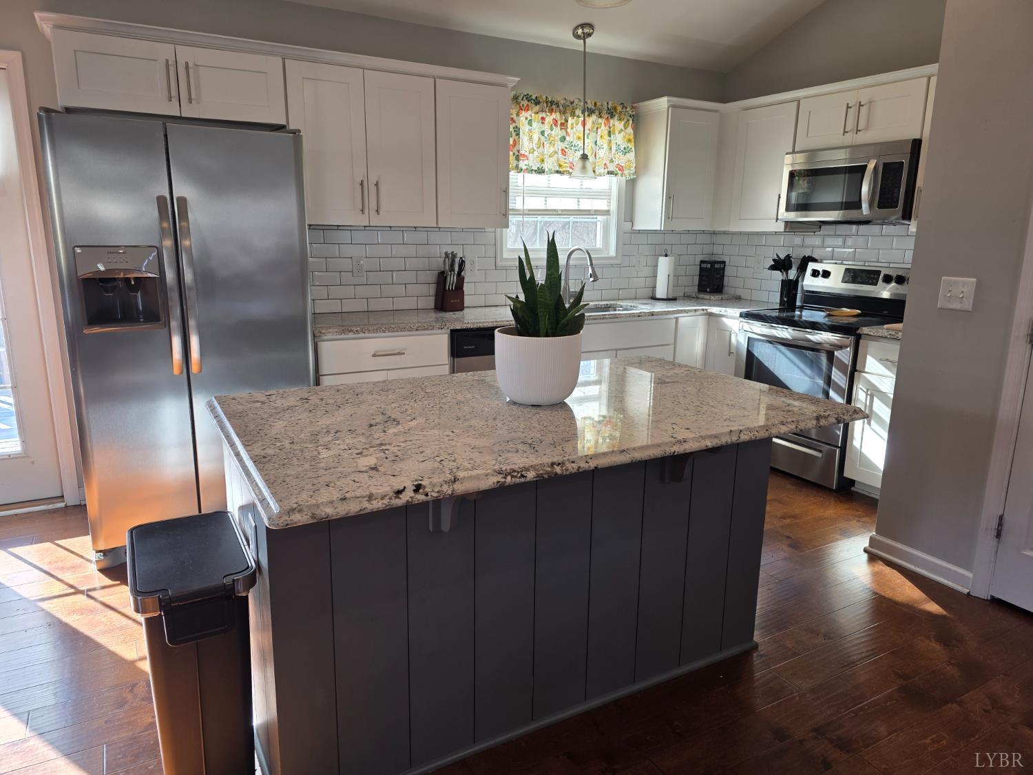 424 Patrick Street Lynchburg, VA 24501 - Photo 11 of 30 a kitchen with kitchen island a counter space a sink appliances and cabinets