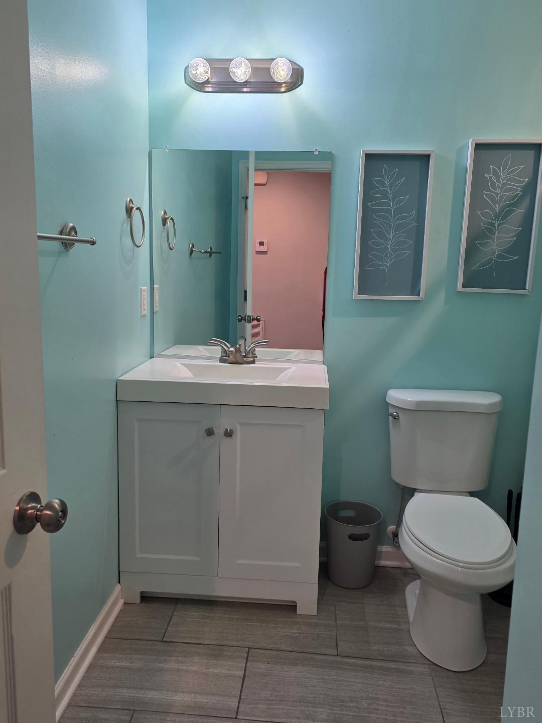 424 Patrick Street Lynchburg, VA 24501 - Photo 18 of 30 a bathroom with a toilet sink and mirror