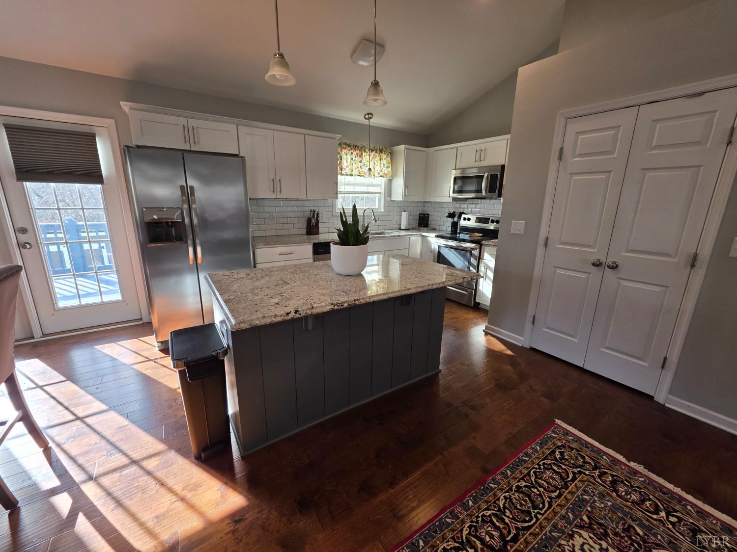 424 Patrick Street Lynchburg, VA 24501 - Photo 8 of 30 a kitchen with granite countertop a refrigerator a sink dishwasher a stove and white cabinets with wooden floor