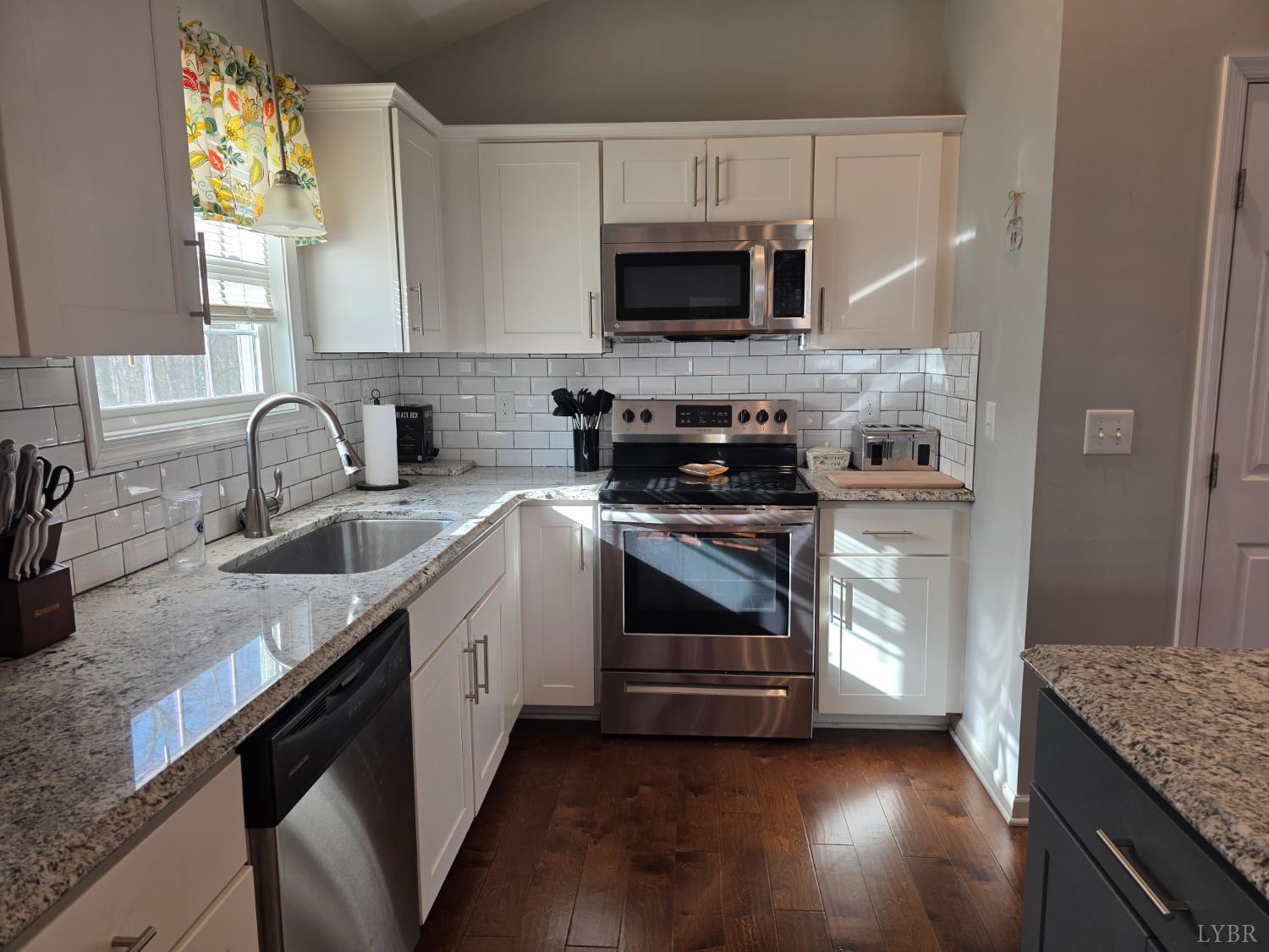 424 Patrick Street Lynchburg, VA 24501 - Photo 10 of 30 a kitchen with granite countertop a sink a stove and microwave