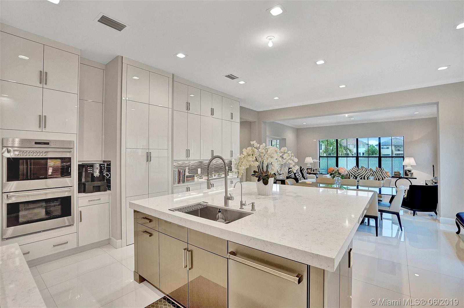 17591 Cadena Drive Boca Raton, FL 33496 - Photo 17 of 56 KITCHEN VIEW + FAMILY ROOM IN THE BACKGROUND