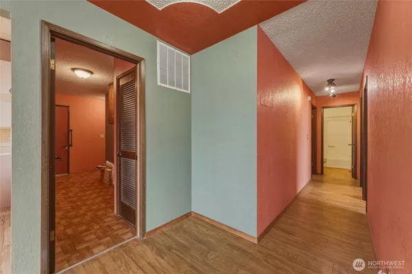 a view of a hallway with wooden floor