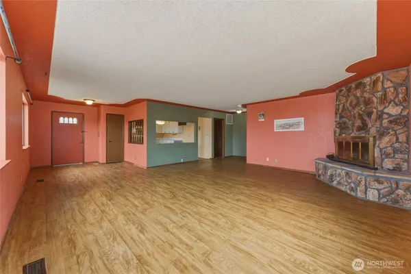a view of empty room with a fireplace