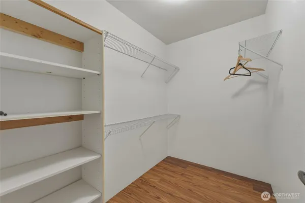 a view of walk in closet with empty racks