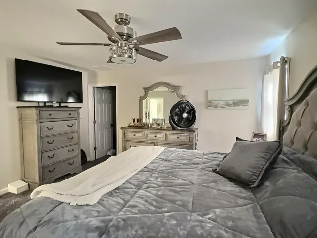 a white bath tub sitting next to a bathroom sink