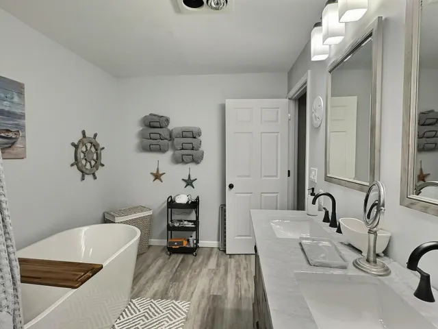 a bathroom with double sink and a mirror