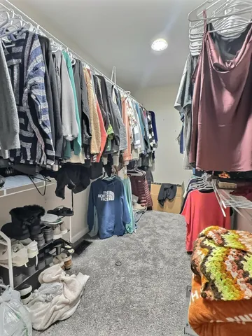 a bed room with a bed and a chair