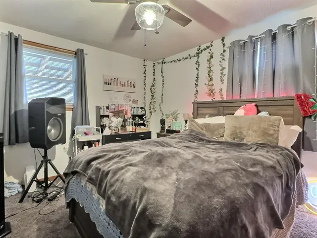 a bedroom with a bed and a window