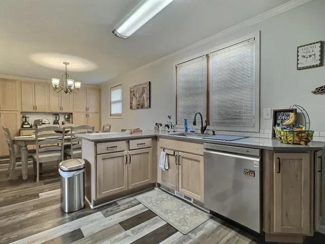 a kitchen with a stove a sink and a refrigerator