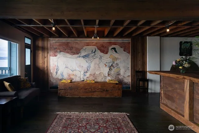 a living room with furniture and a floor to ceiling window