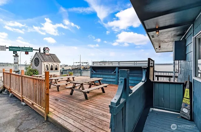 a view of a roof deck with table and chairs