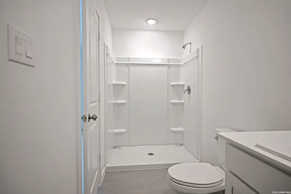 a white toilet sitting next to a bathroom sink