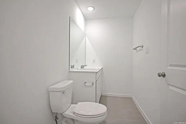 an empty room with windows and ceiling fan