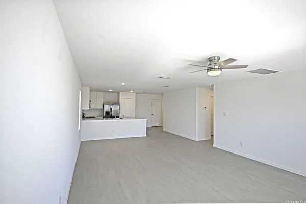 a view of a livingroom with a ceiling fan and window