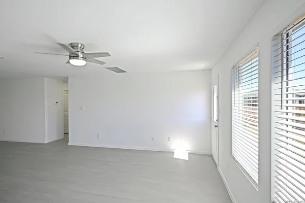 a view of a backyard with wooden fence