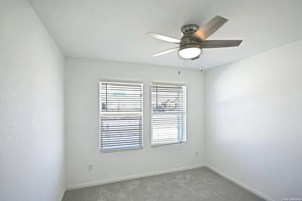 a view of a hallway with a chandelier fan