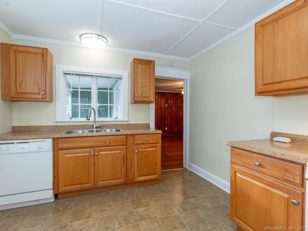 a kitchen with granite countertop a sink stainless steel appliances and cabinets