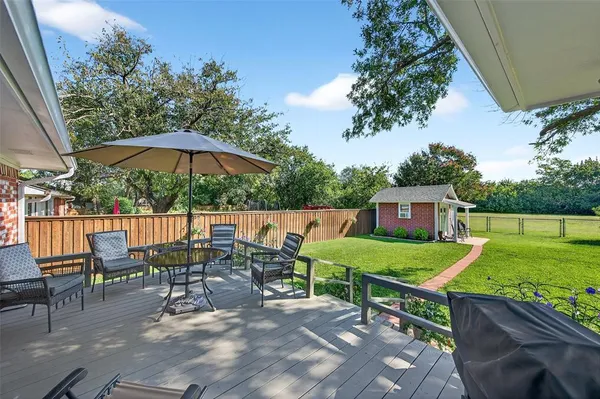 an outdoor space with furniture and umbrella
