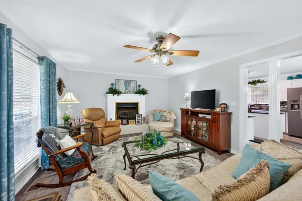 a living room with furniture a fireplace and a flat screen tv