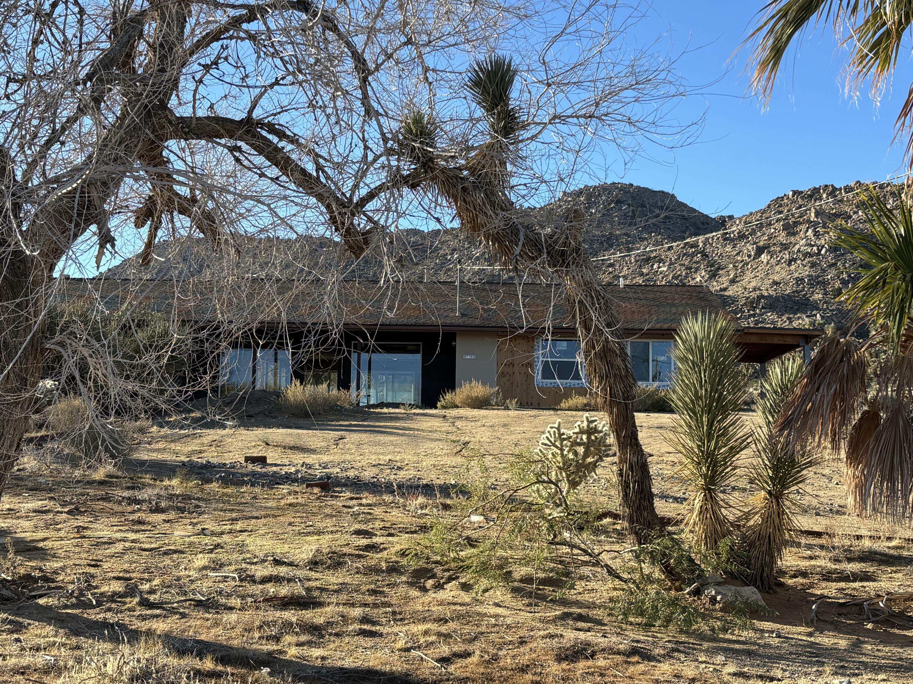 60959 Prescott Trail Joshua Tree, CA 92252 - Photo 2 of 30 a front view of a house with a yard