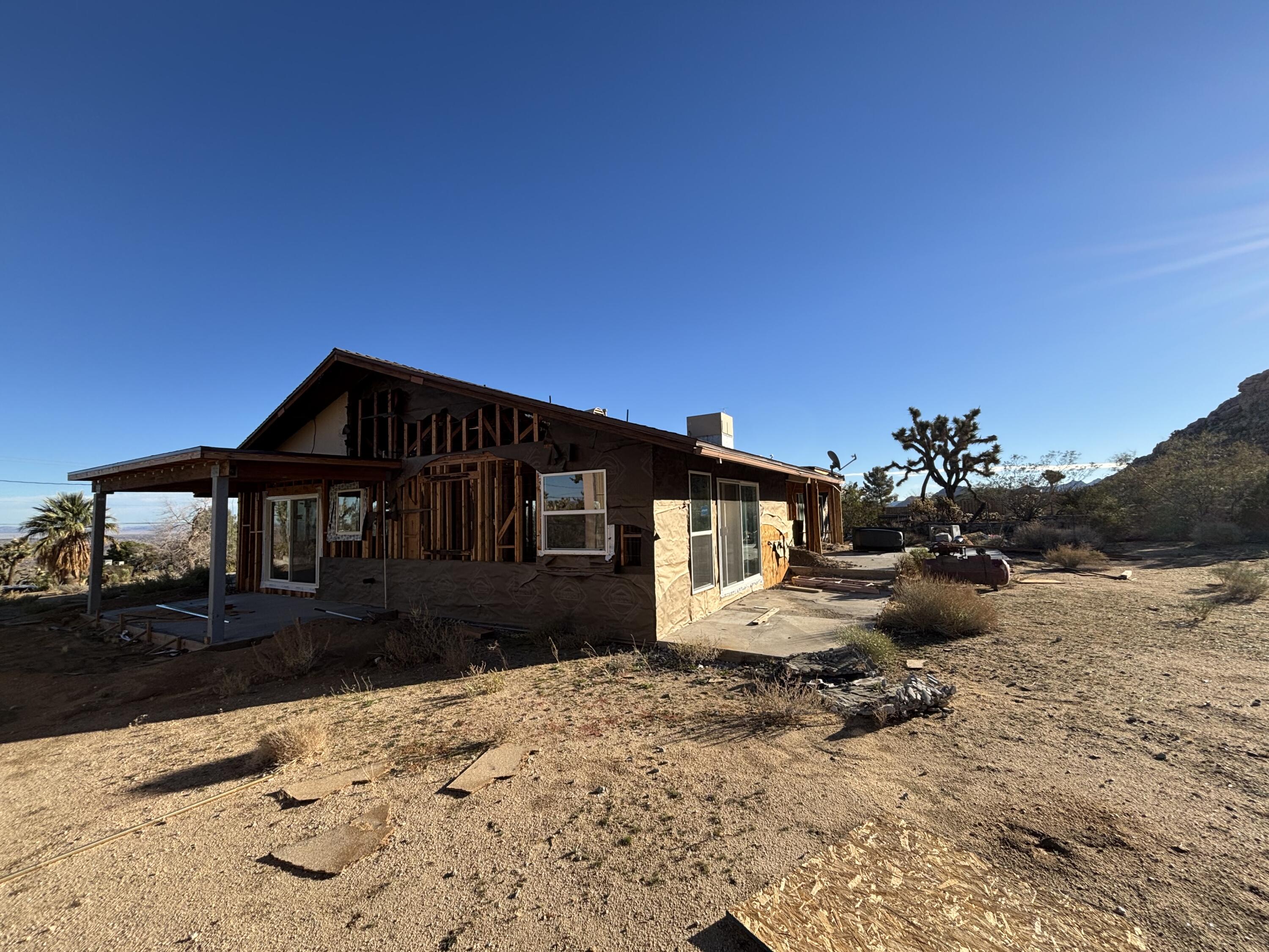 60959 Prescott Trail Joshua Tree, CA 92252 - Photo 28 of 30 a front view of a house with a yard covered in snow