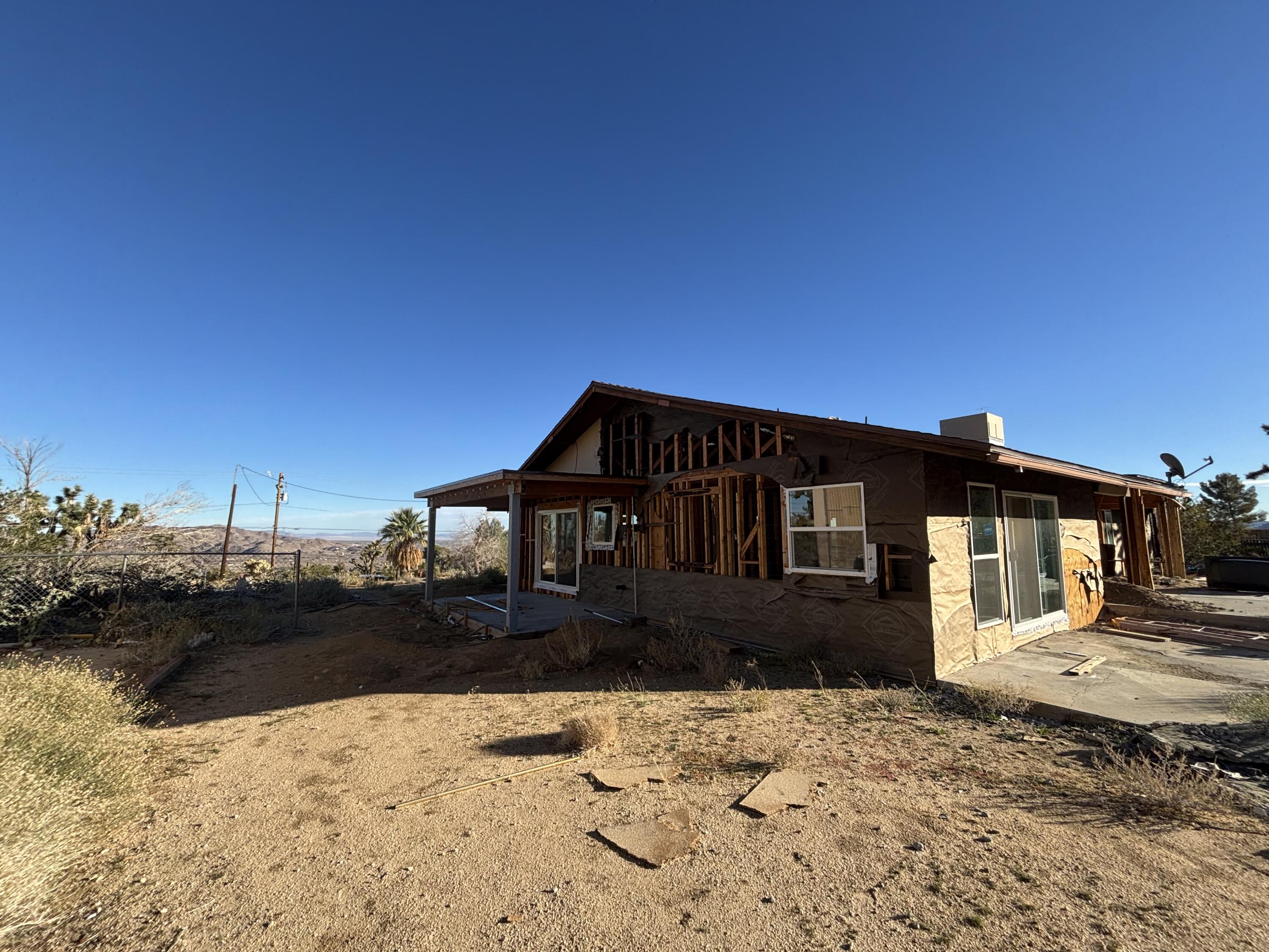 60959 Prescott Trail Joshua Tree, CA 92252 - Photo 29 of 30 a front view of a house with a yard