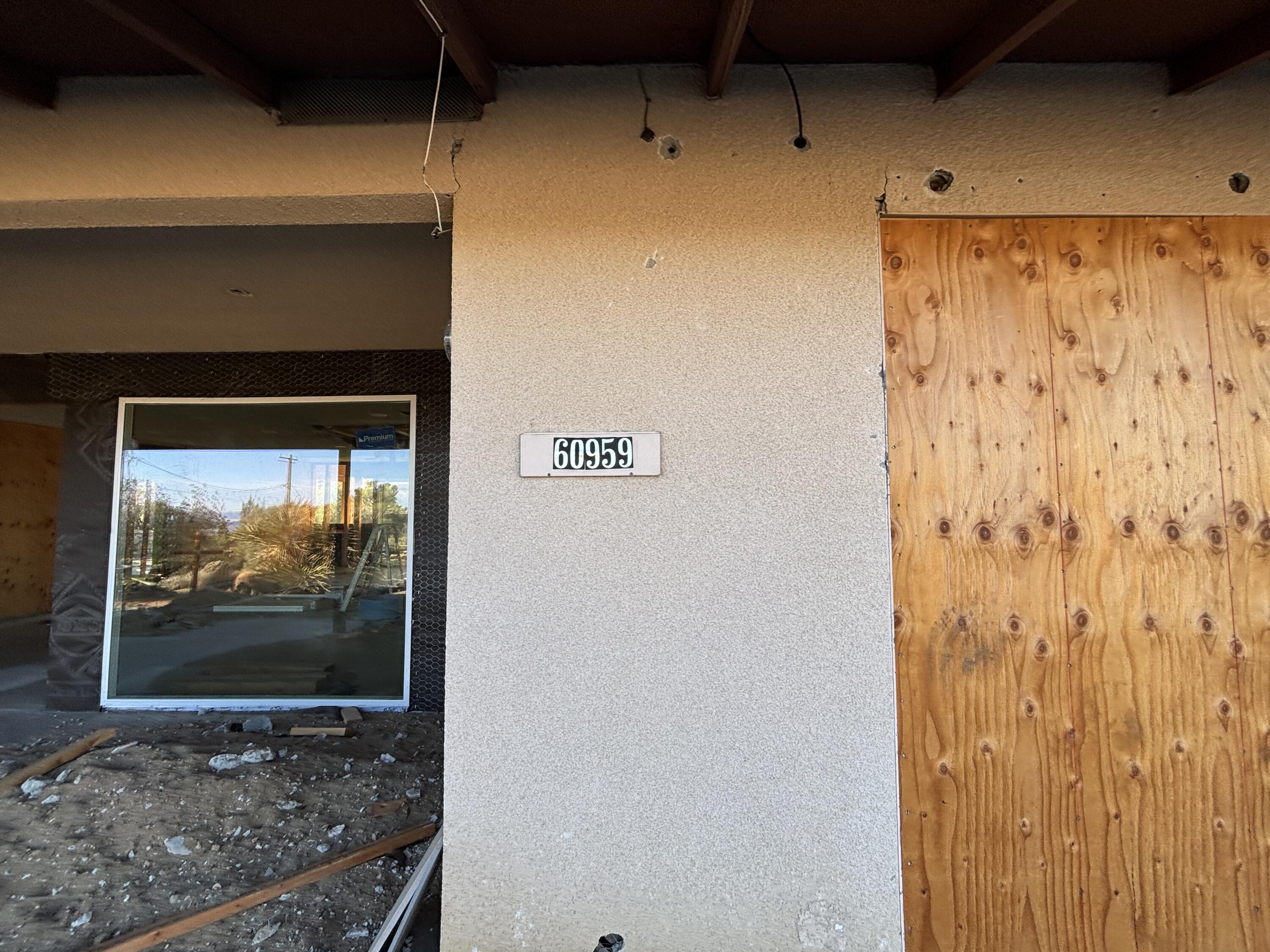 60959 Prescott Trail Joshua Tree, CA 92252 - Photo 3 of 30 a view of a room with rack on the wall and a flat screen tv