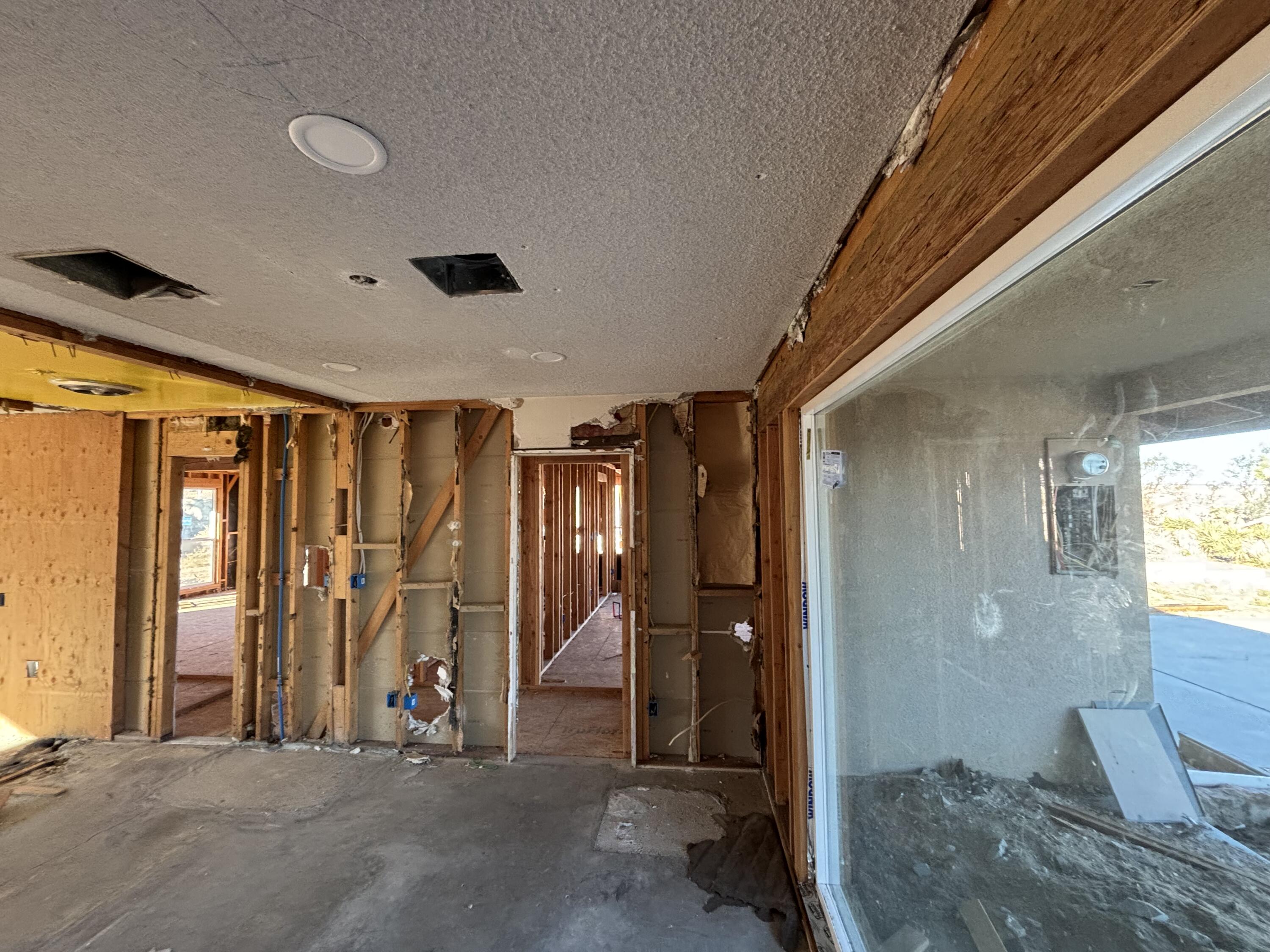 60959 Prescott Trail Joshua Tree, CA 92252 - Photo 7 of 30 a view of a hallway with wooden staircase and door