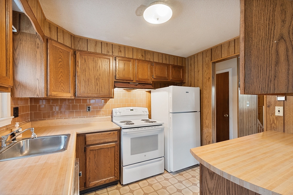 69 Little Turnpike Road Shirley, MA 01464 - Photo 24 of 37 a kitchen with a sink a stove and refrigerator
